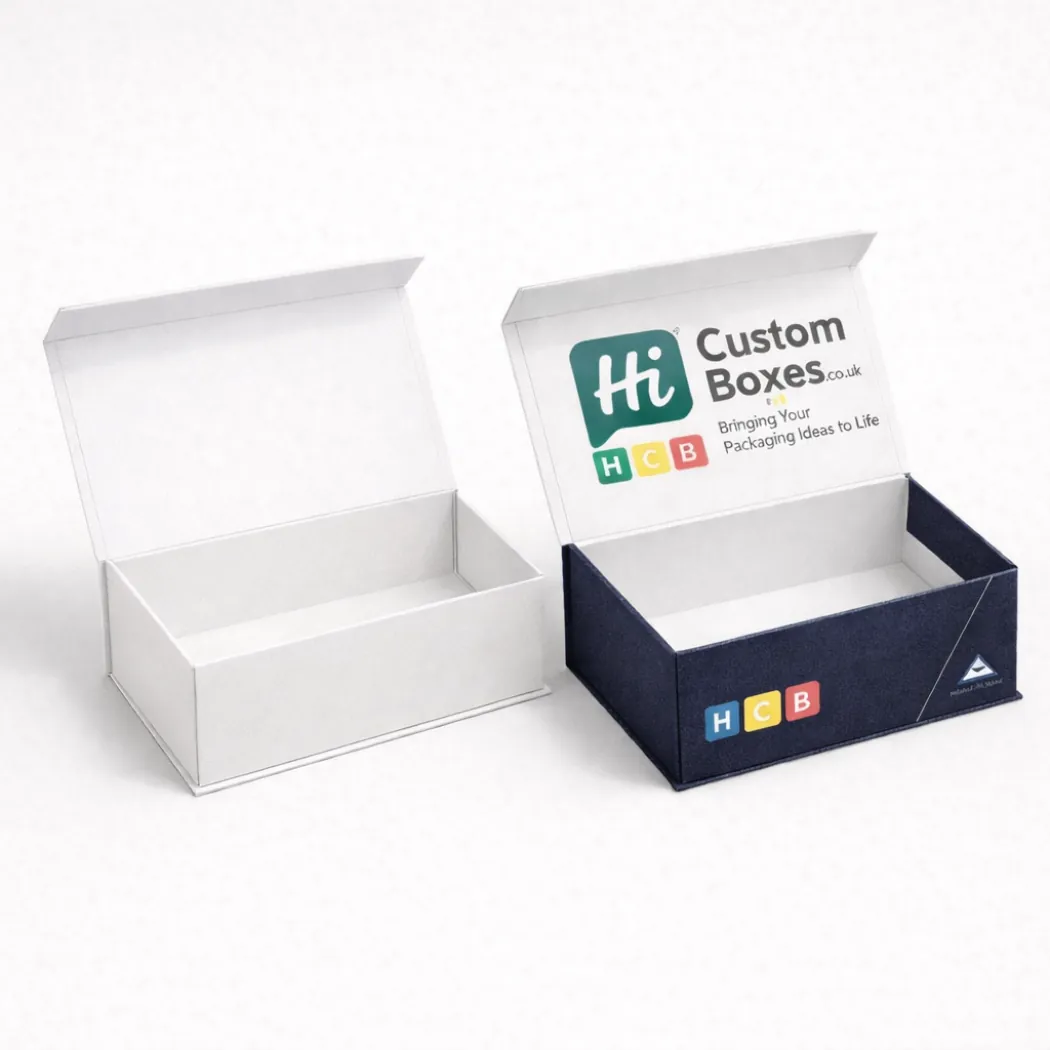 Two open mailing boxes containing folded shirts- showcasing a plain white and a branded navy design- class=